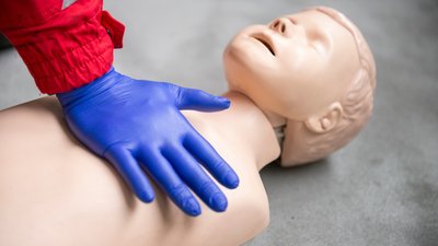 Paramedic practicing bls and cpr on a child mannequin